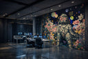 School interior featuring a mixed media collage mural by Dave Krovblit, combining layered imagery with themes of identity and expression.